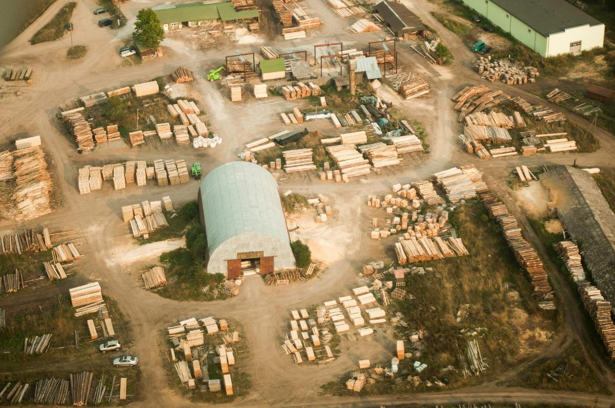 Aerial view of a timber yard with wood piles